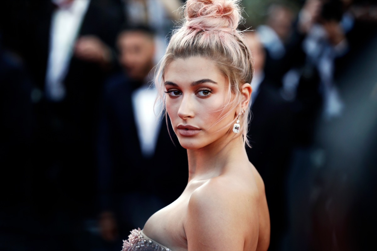 Hailey Baldwin sports a gold bra for Harper's Bazaar