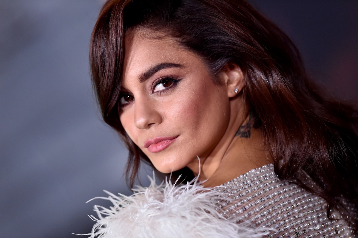 Vanessa Hudgens dances on the beach in a 2000s boho outfit