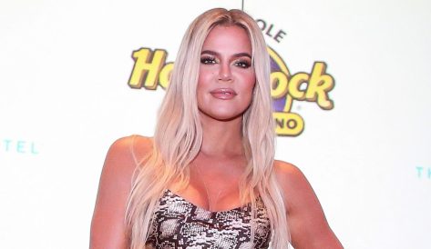 Khloe Kardashian Shows Off Swimsuit While Lying in the Sand