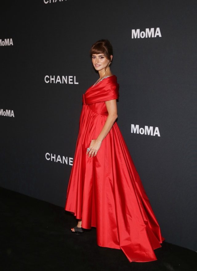 Penelope Cruz shines in a black satin Chanel gown with a string of