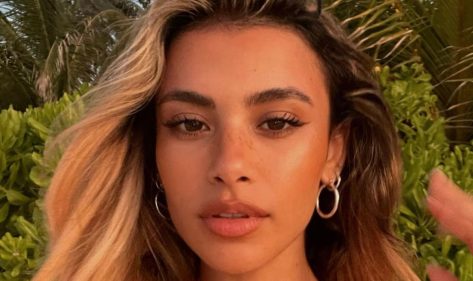 Joanna Chimonides in Bathing Suit is “Trying to Look Cute”