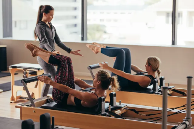 Pilates on reformer and heart Beach Towel by sashica