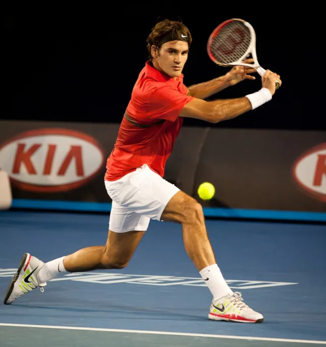 MELBOURNE - JANUARY 22:Roger federer of Switzerland in hiw fourth round win over Bernard Tomic of Australia at the 2012 Australian Open on January 22, 2012 in Melbourne, Australia.