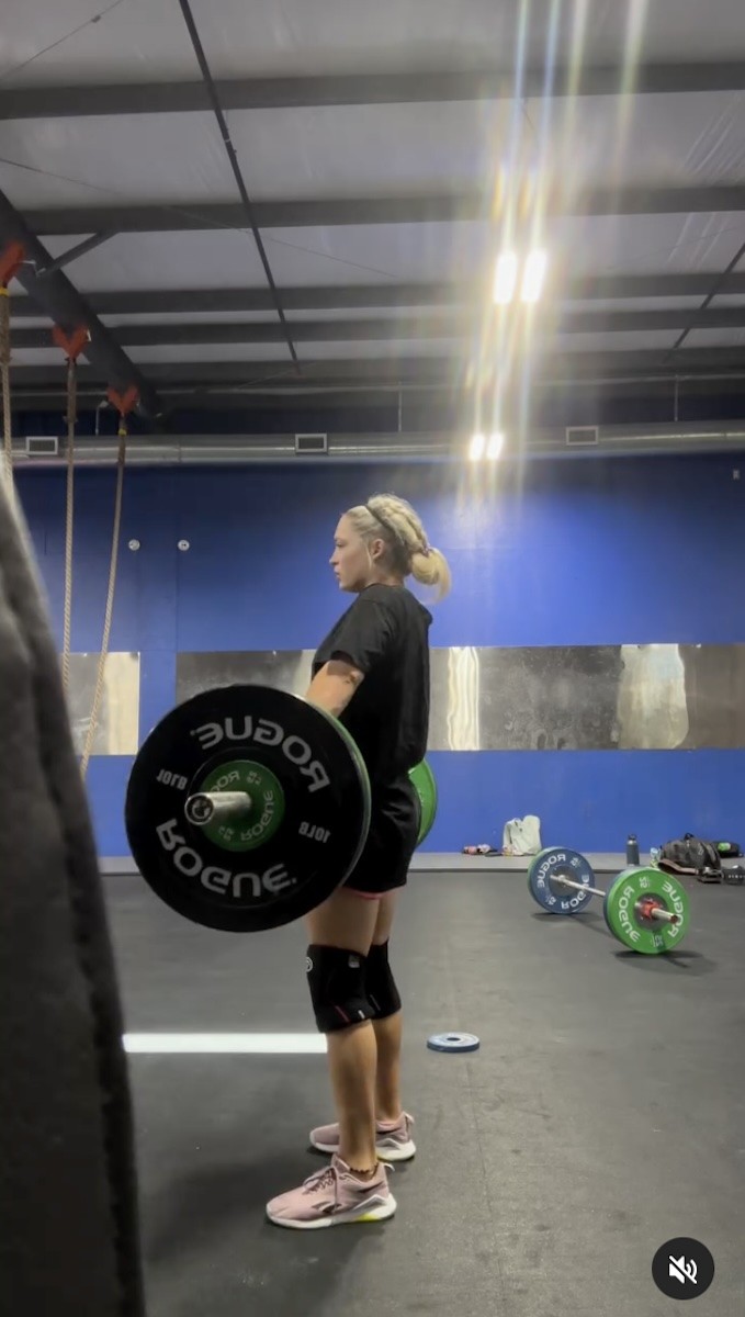 Haley Adams is seen lifting weights.