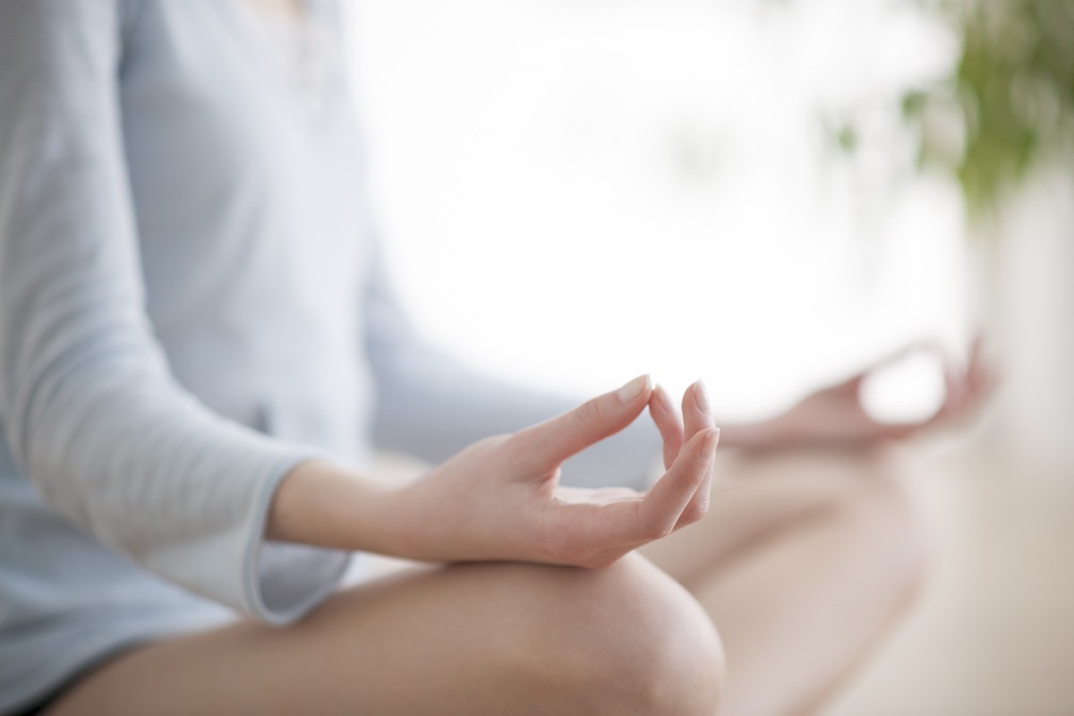 Woman,Meditating,In,The,Lotus,Position,Closeup