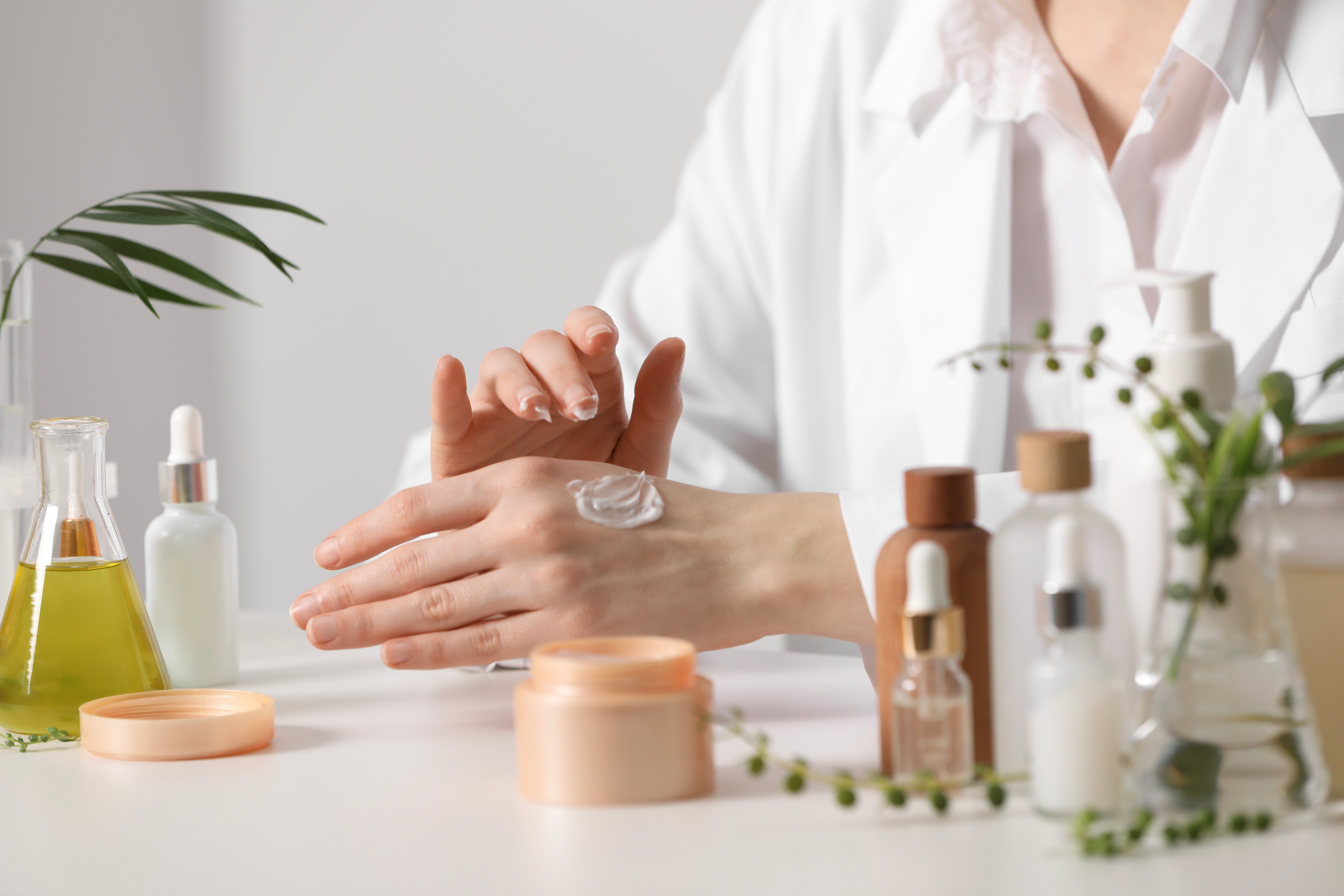 Stock photo of a Dermatologist apply cream to her hand.