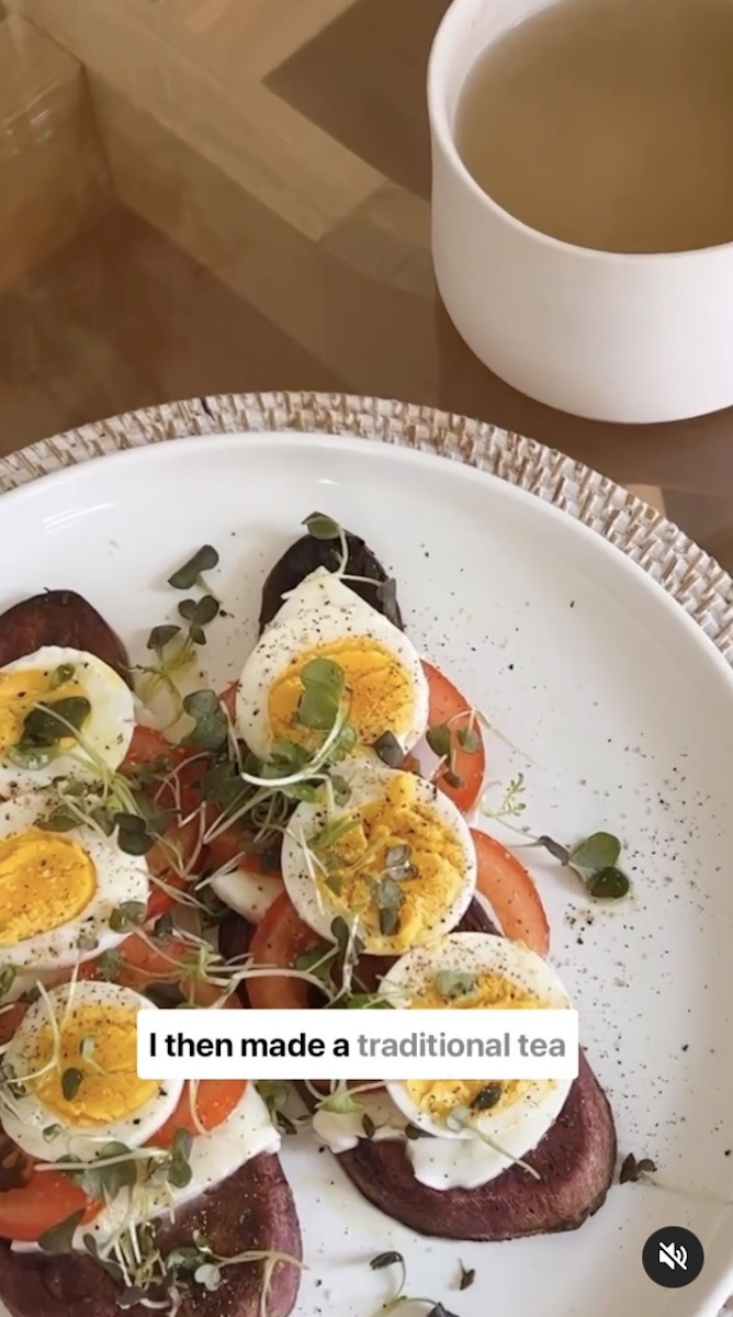 Sweet potato toast topped with eggs, mozzarella, sprouts, and tomatoes.