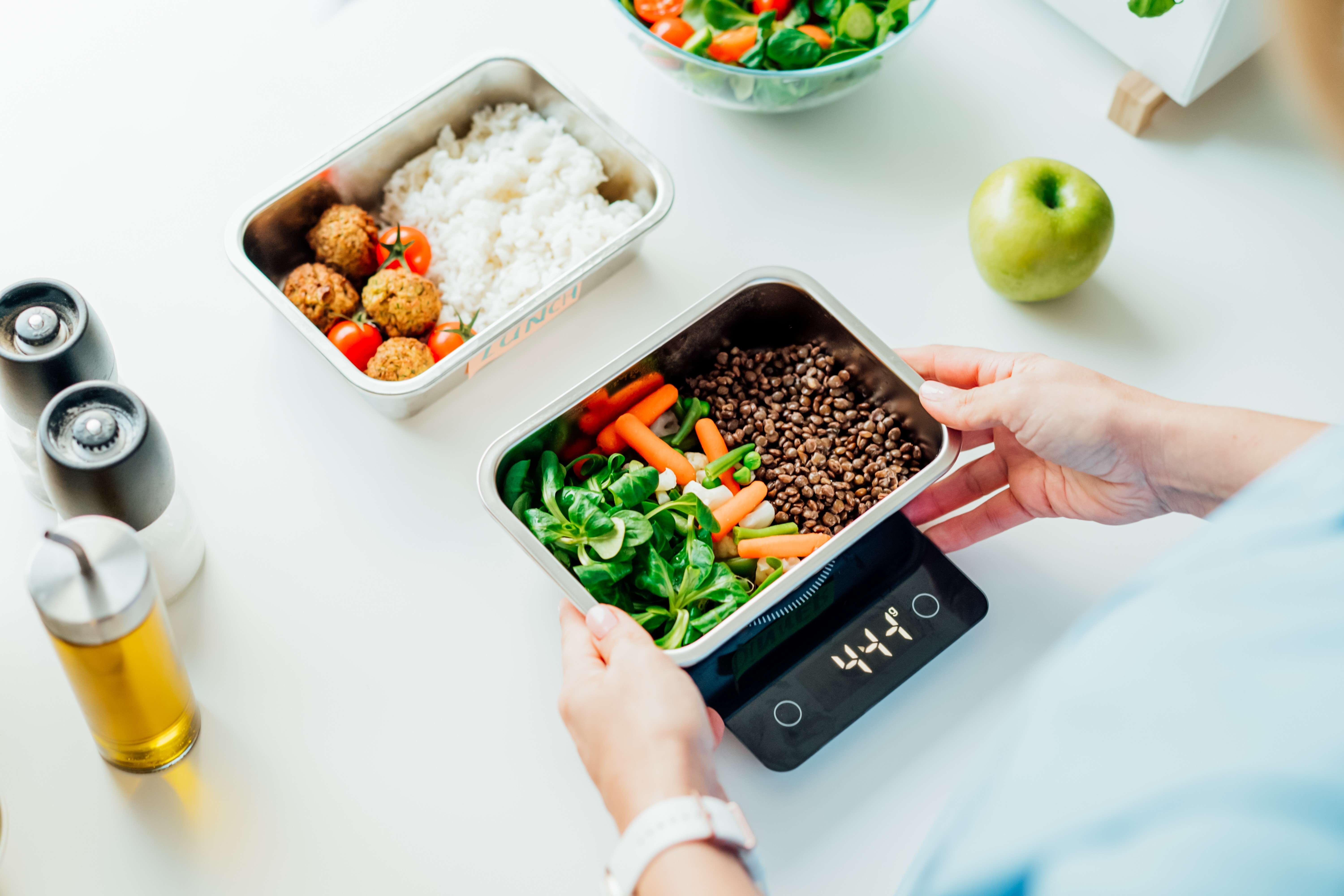 A woman's hands weighing food.