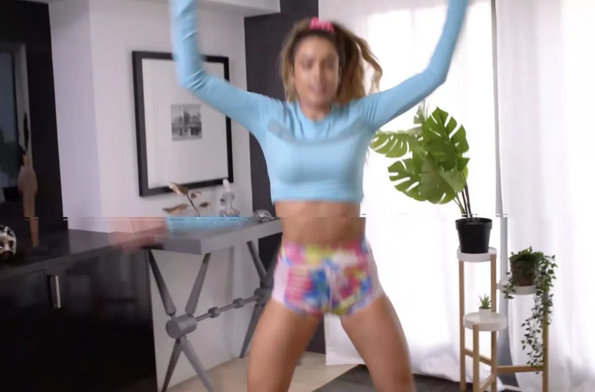 Sommer Ray does jumping jacks.