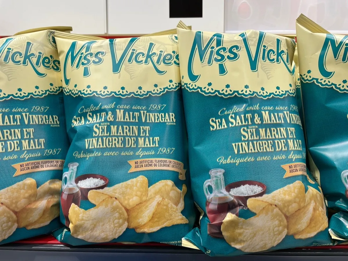 Bags of salt and vinegar chips on the shelf at the grocery store.