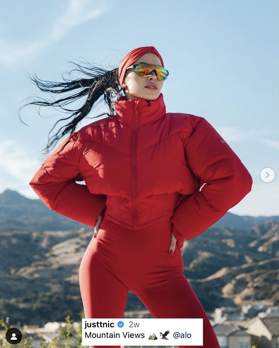 Nicole Williams English poses atop a mountain.