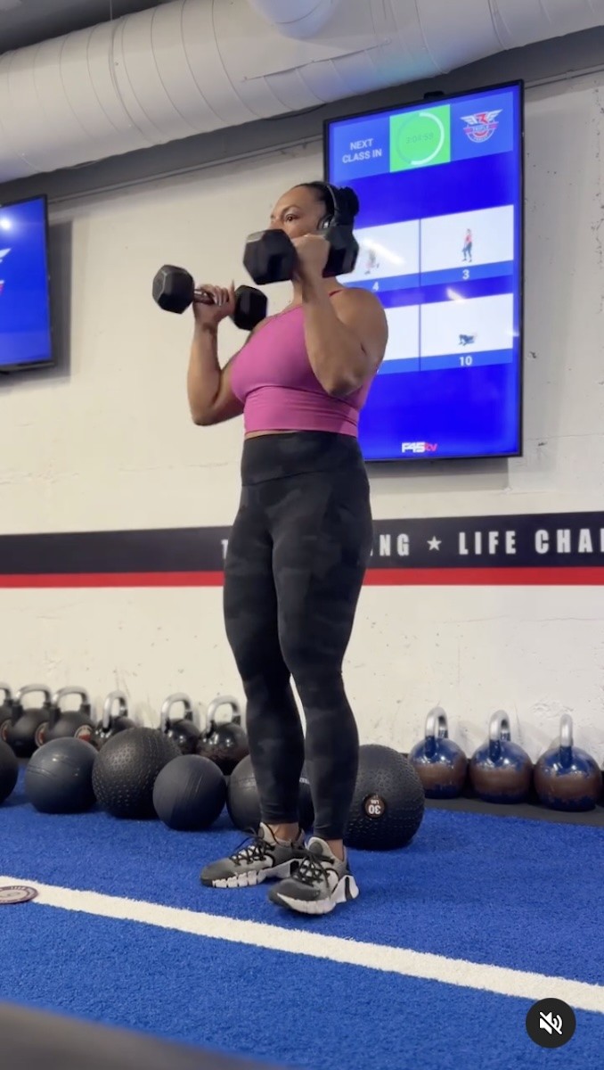 Alicia Bell is seen using weights during a workout.