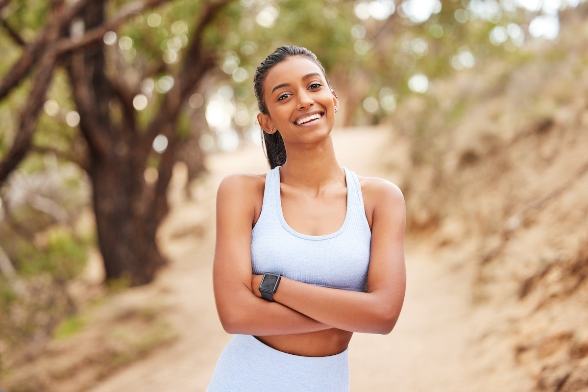 Stock photo of a beautiful Indian woman cooling down after a jog.