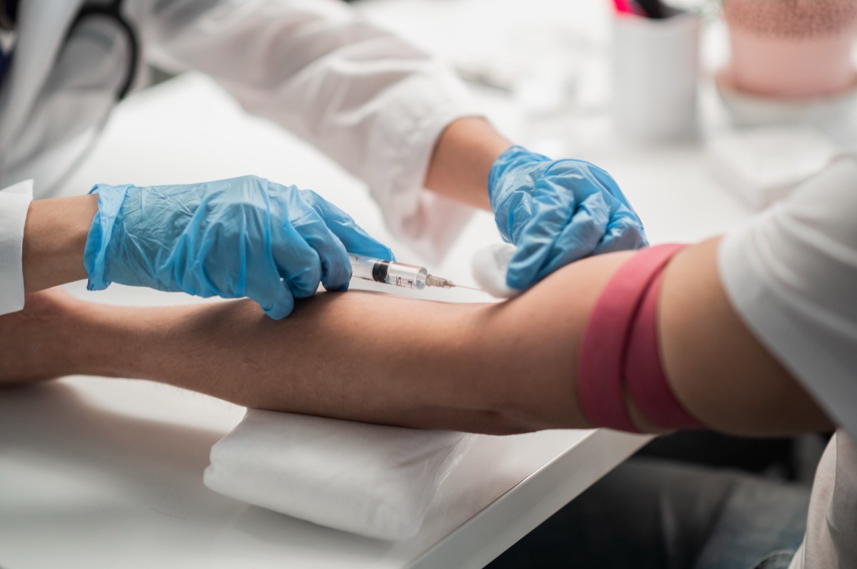 A nurse taking blood from a patient