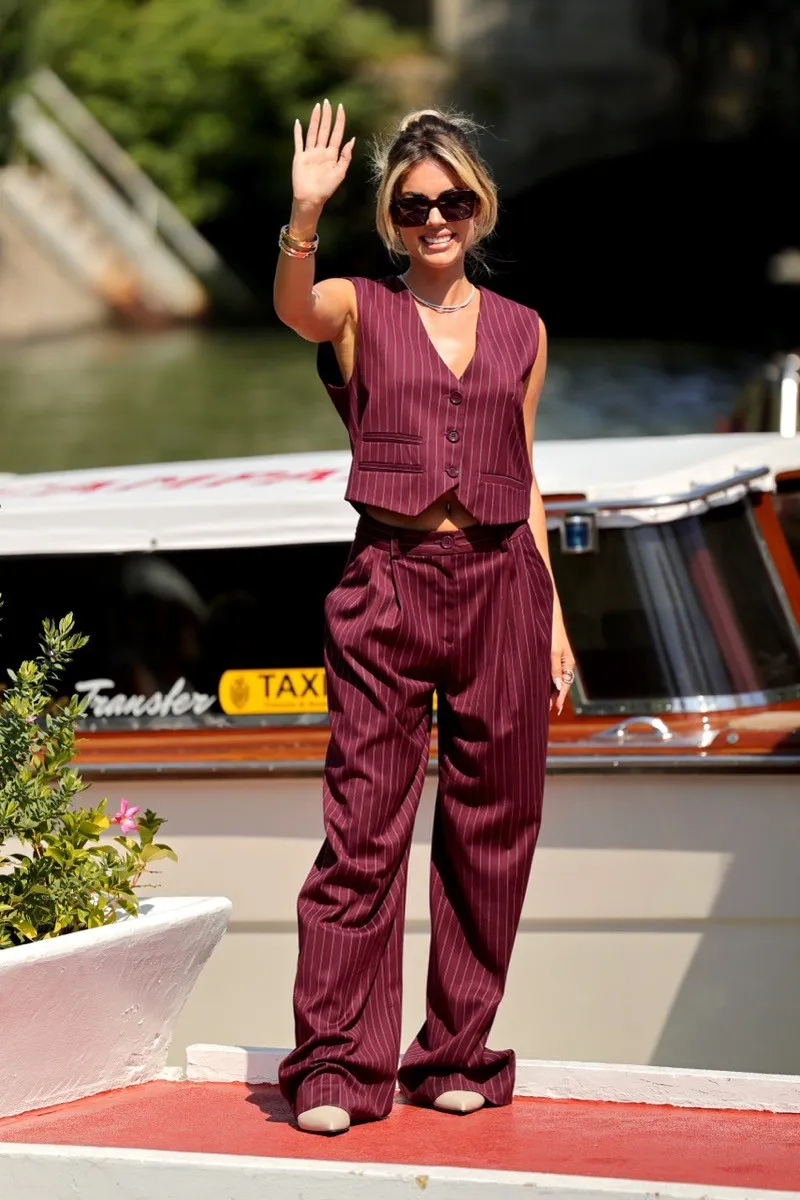 Ludovica Pagani waves to fans as she arrives in Venice for the Venice Film Festival