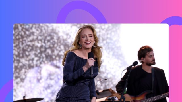 Adele performing onstage in blue off-the-shoulder gown