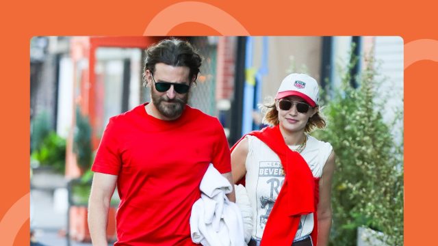 Bradley Cooper and Gigi Hadid both in coordinating red outfits walking on sidewalk