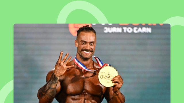 Chris Bumstead holding Olympia medal