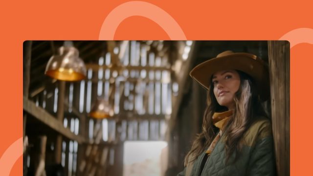 screenshot from 'Ransom Canyon' trailer of Minka Kelly in cowgirl hat standing in stables