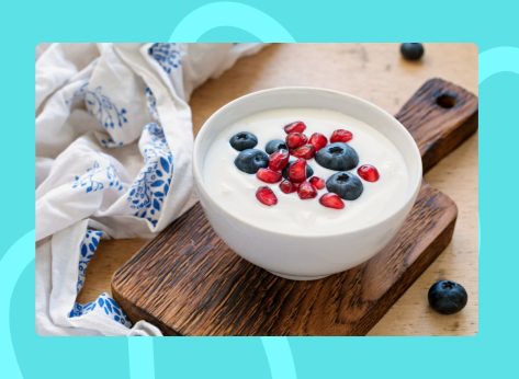 bowl of yogurt with berries on a cutting board