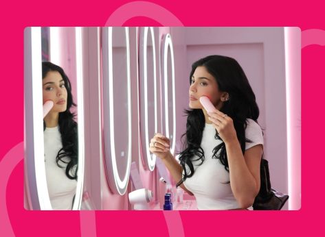 Kylie Jenner using red light device while looking in mirror